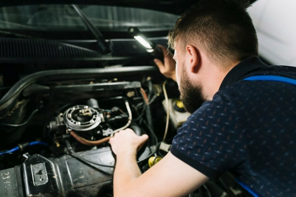 repairmen-inspecting-vehicle-engine_23-2147897987.jpg